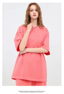 Model wearing a vintage washed coral heavy cotton oversized t-shirt in a studio setting.