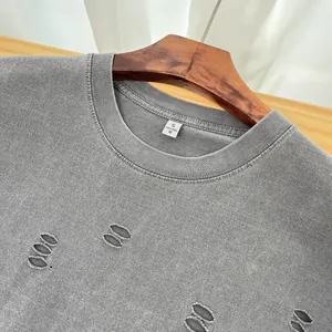 Close-up of gray heavyweight washed T-shirt with stylish distressed hole details