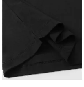Gros plan sur la fente latérale et les coutures d'un t-shirt noir épais et lourd