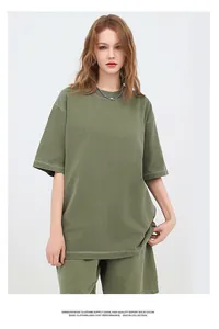 Oversized army green washed cotton T-shirt set shown on model in a minimalist studio