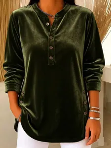 Detailed view of women's dark green velvet long-sleeved casual top with decorative buttons