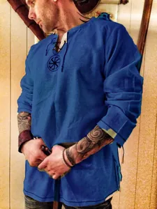 Close-up detail of blue long-sleeved T-shirt with lace-up neck and Slavic sun symbol