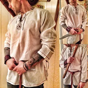 Detailed view of men's medieval Viking linen tunic with Slavic sun symbol embroidery