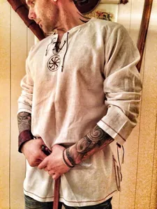 Men's beige medieval style lace-up tunic shirt featuring Slavic sun symbol print