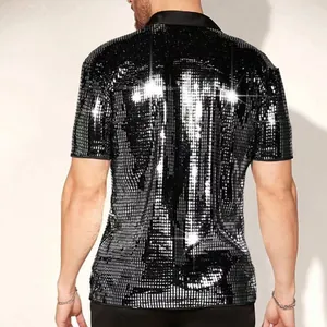 Macro detail of the sparkling black sequin fabric on a men's stylish short-sleeved polo shirt