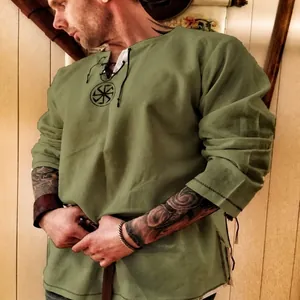 Vintage men's medieval lace-up linen shirt in olive green with ethnic sunwheel embroidery