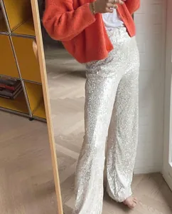 Full-length view of silver sequined wide-leg trousers in a stylish indoor mirror selfie.