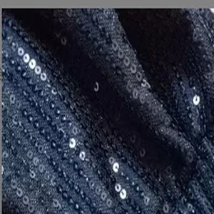 Close-up of shimmering dark blue sequins on fashion slim-fit hot pants material