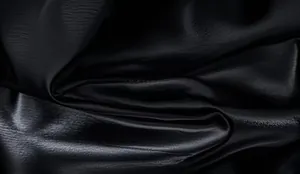 Close-up of black shiny fabric texture for stage party men's t-shirt detail view