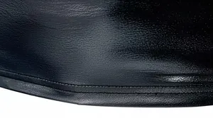 Macro detail shot showing the glossy black fabric texture and hem stitching of a men's t-shirt.