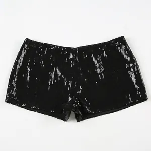 Close-up detail of black sequined low-waist hot pants with sparkly textured fabric