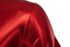 Close-up of shiny red metallic fabric showing high-quality shoulder seam stitching