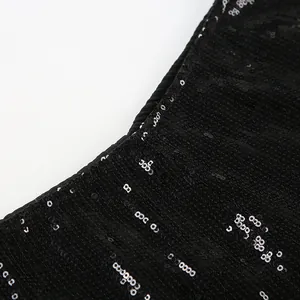 Detailed close-up showing texture of black shimmering sequins on stylish hot pants