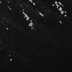 Detailed close-up showing texture of shiny black sequins on fashion slim fit hot pants