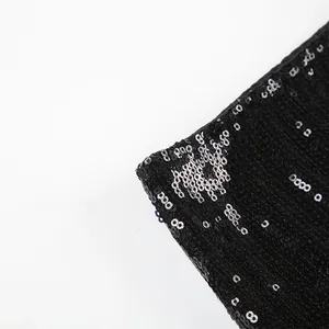 Macro shot showing the detailed texture of black shimmering sequins on stylish hot pants