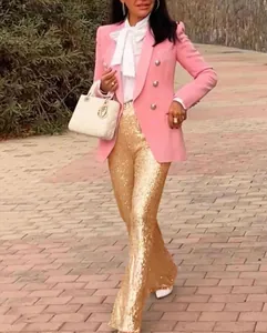 Detailed look at elegant gold sequins on high-waisted fashion trousers for women