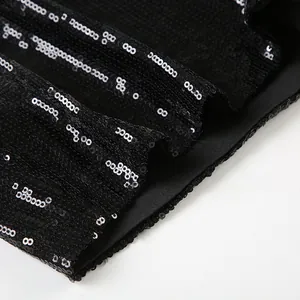 Close-up detail of high-quality black sequined fabric on stylish shorts hemline