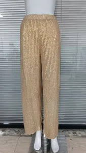 Close-up detail of glamorous gold sequined high-waist straight-leg trousers for women