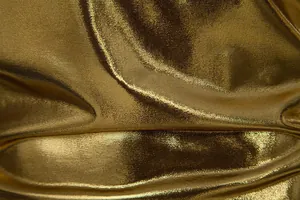 Close-up detail of shiny gold metallic fabric for men's stage performance T-shirt