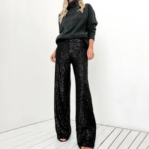 Full view of women's high-waisted black sequin straight-leg trousers in a studio setting