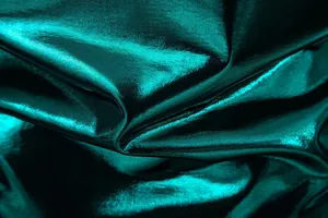 Close-up detail of teal green metallic shiny fabric for party stage T-shirt