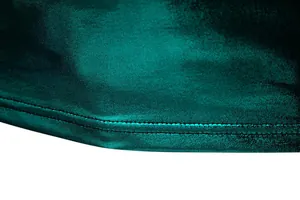 Macro detail showing the shiny metallic dark green fabric and precision hem stitching