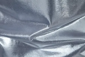 Close-up macro view of silver metallic fabric with shiny texture for stage performance