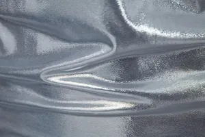 Close-up of the premium metallic silver shiny fabric texture for the men's party stage T-shirt.