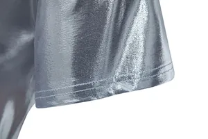 Detailed close-up of the silver metallic fabric and double stitching on a men's shiny T-shirt sleeve