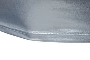 Macro detail of the double-stitched hem on a silver metallic shiny party T-shirt