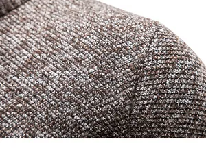 Close-up macro view showing the thick knitted texture of a men's wool cardigan sweater