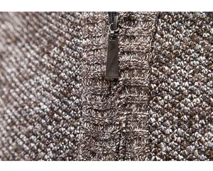 Close-up of high-quality brown knit texture and durable metallic zipper on men's cardigan.