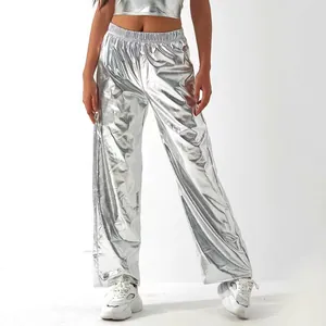 Detail view of metallic silver wide-leg pants featuring a shiny holographic finish