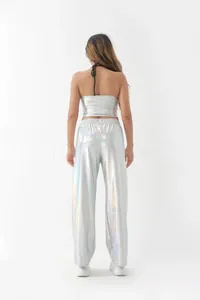 Back view of silver holographic metallic two-piece set with halter top and wide-leg pants