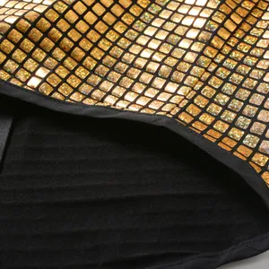 Close-up detail of golden shiny grid fabric and black striped lining of cosplay shirt