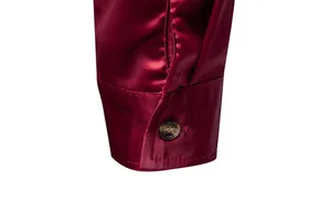 Primo piano del polsino di una camicia da uomo in raso bordeaux con trama setosa e lucida