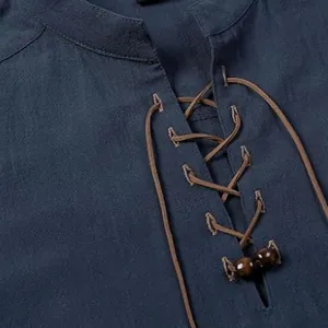 Macro view of the lace-up drawstring collar with decorative wooden beads on a blue casual shirt.