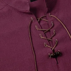 Close-up of men's burgundy linen-textured Henley shirt with lace-up collar and beads.