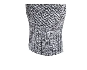 Close-up of grey heathered knit texture and ribbed cuff of a men's winter sweater.