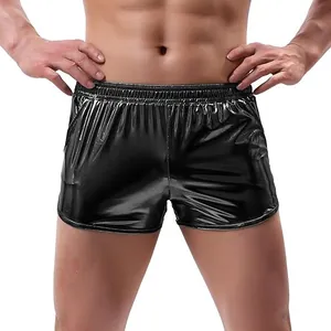 Detail view of men's shiny black shorts featuring metallic fabric and elastic waistband