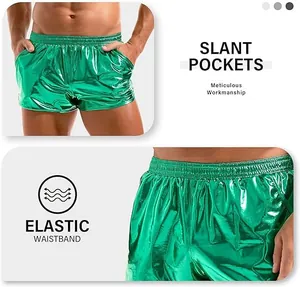 Close-up detail of shiny green metallic men's shorts with elastic waistband and pockets