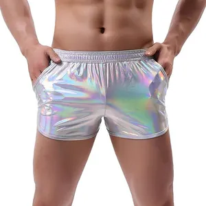 Detailed view of men's silver holographic shorts with shiny metallic finish and elastic waist