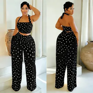 Ensemble deux pièces à pois noir et blanc avec haut licou et pantalon large à franges