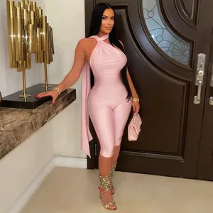 Fashionable sexy pink halter neck backless bodycon jumpsuit for women in an elegant home setting