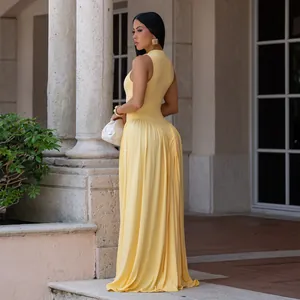 Elegant yellow sleeveless round neck maxi dress with pleated skirt detail in a chic setting