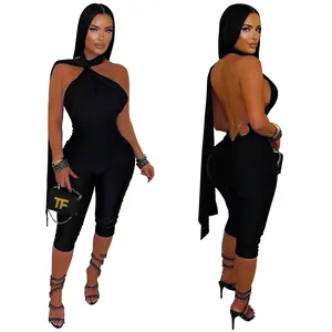 Backless black bodycon jumpsuit with halter neck and cutout design detail shown on model