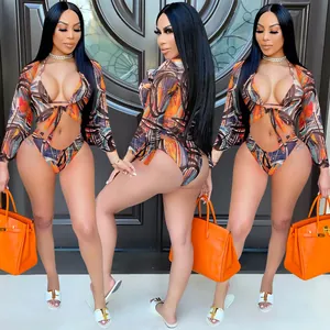 Detailed view of sexy 3-piece bikini set with colorful abstract print and mesh cover-up