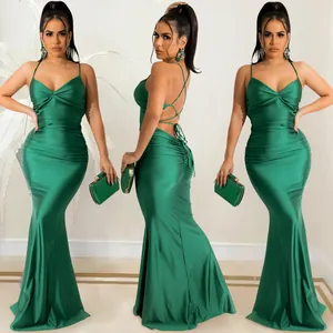 Detailed view of an elegant emerald green backless mermaid evening dress with lace-up design