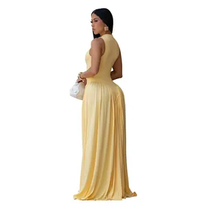 Side detail of elegant pale yellow sleeveless maxi dress with a pleated flowing skirt.