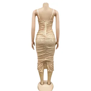 Back view of a shimmering champagne gold sequined midi dress with elegant back slit.
